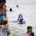 South Lyon resident Ella Garland, 3, walks in the water at Independence Lake on Saturday, July 6. This is her second time at the park. Daniel Brenner I AnnArbor.com